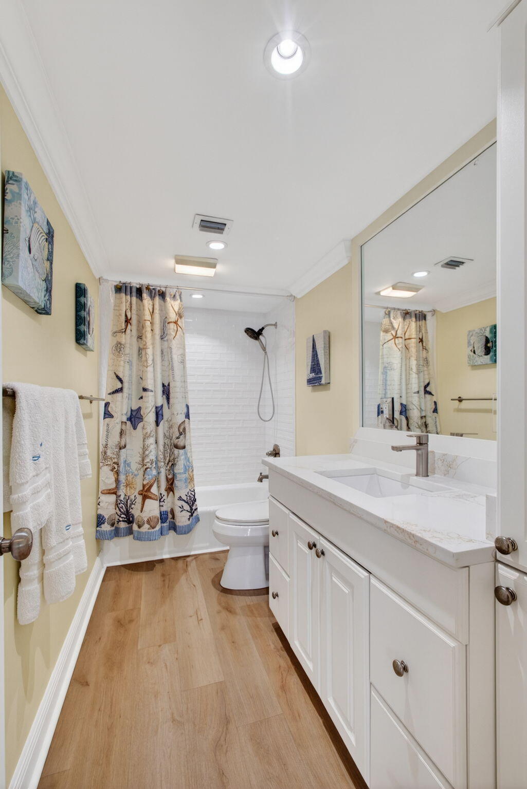 5440 North Ocean Drive, Unit 1006 Riviera Beach, FL 33404 - Photo 29 of 57 a spacious bathroom with a double vanity sink toilet mirror bathtub and shower
