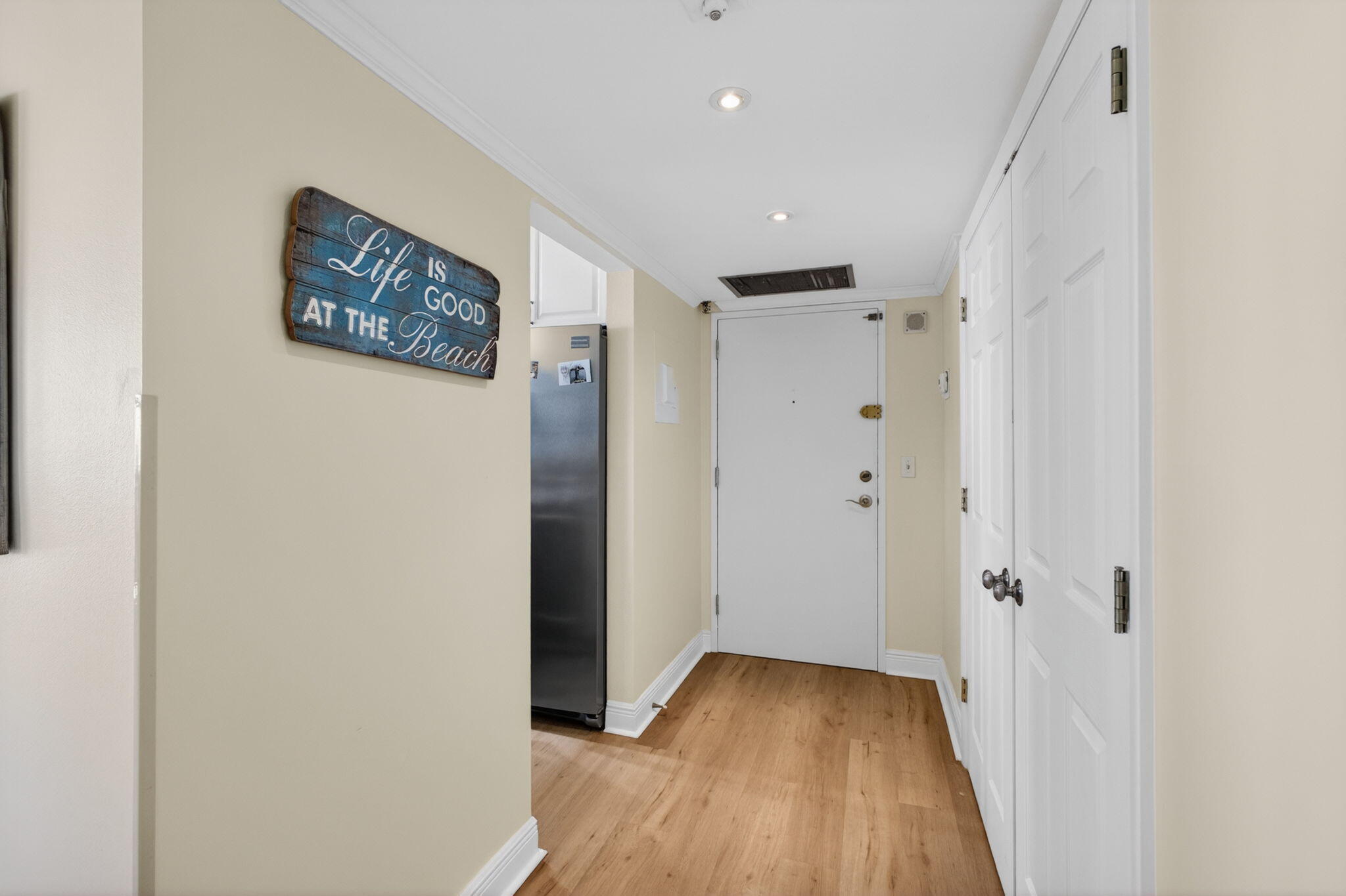 5440 North Ocean Drive, Unit 1006 Riviera Beach, FL 33404 - Photo 5 of 57 a view of a hallway with wooden floor