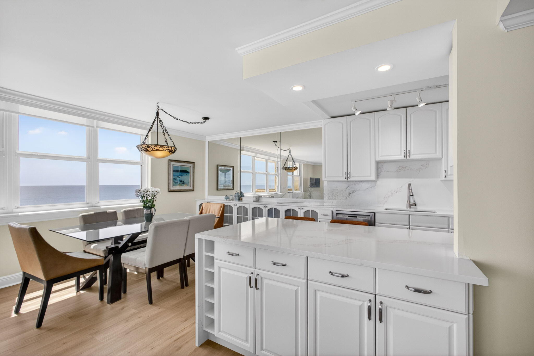 5440 North Ocean Drive, Unit 1006 Riviera Beach, FL 33404 - Photo 7 of 57 a kitchen with granite countertop a table chairs stove and cabinets
