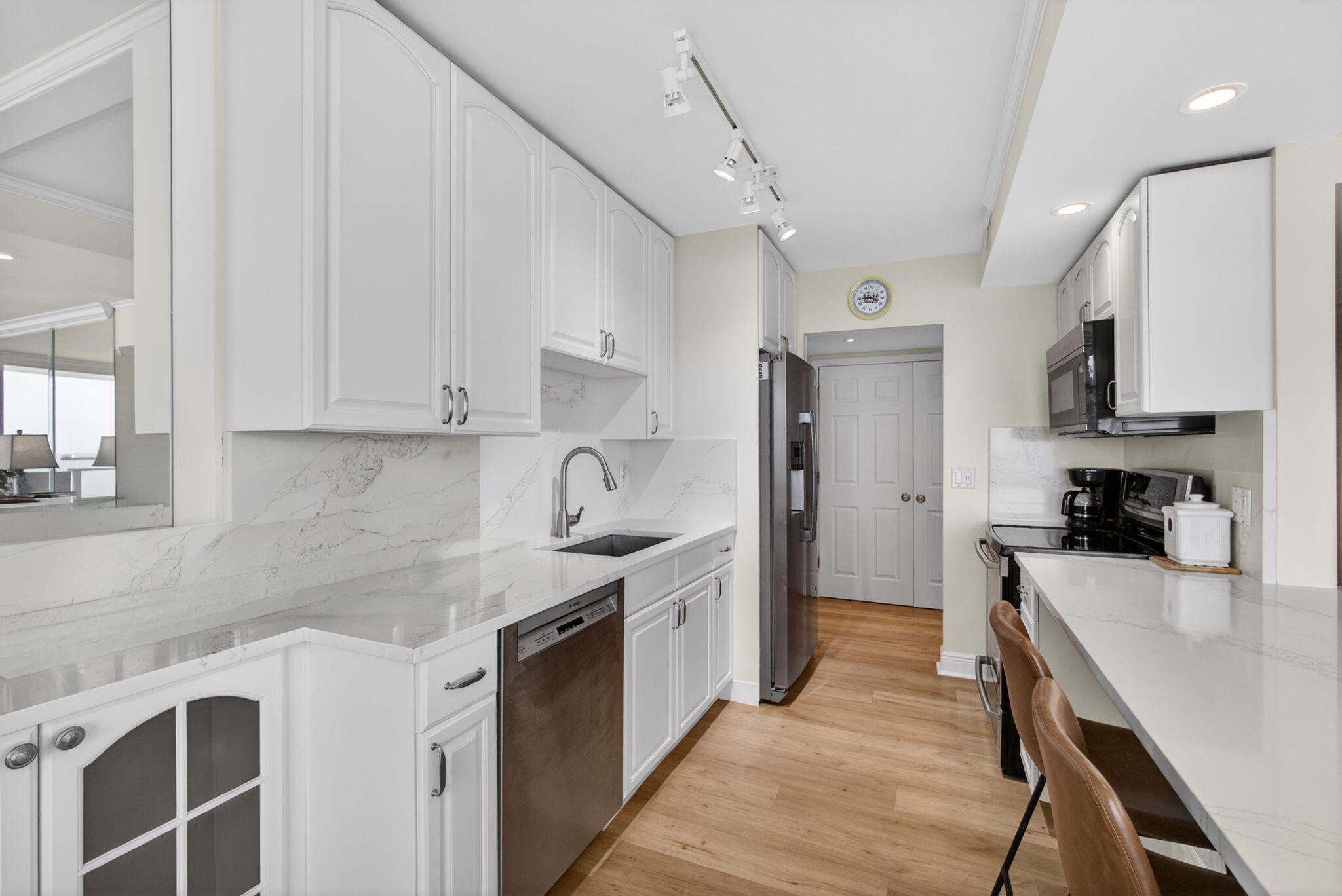 5440 North Ocean Drive, Unit 1006 Riviera Beach, FL 33404 - Photo 10 of 57 a kitchen with stainless steel appliances granite countertop a sink stove and refrigerator