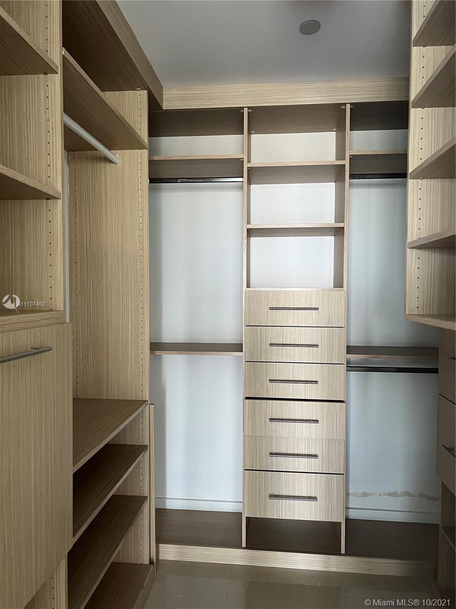 1100 Biscayne Boulevard, Unit 4504 Miami, FL 33132 - Photo 11 of 21 a view of walk in closet with empty racks