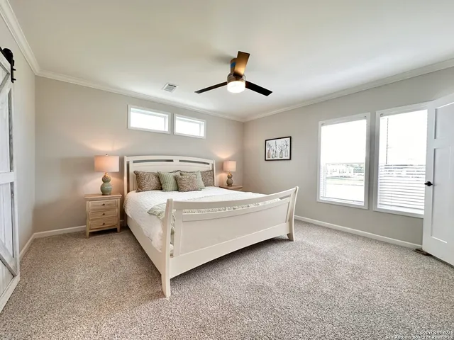 a bedroom with a large bed and a large window