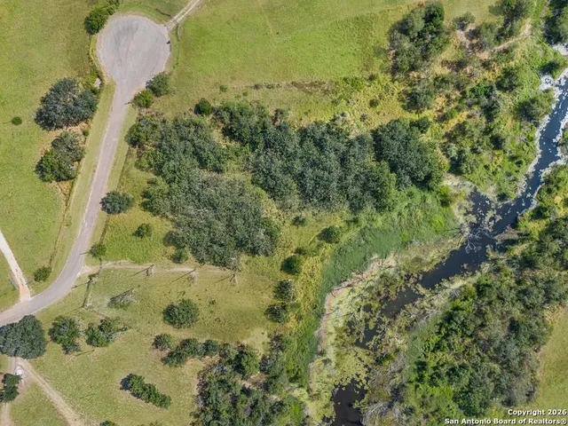 an aerial view of a house with a yard