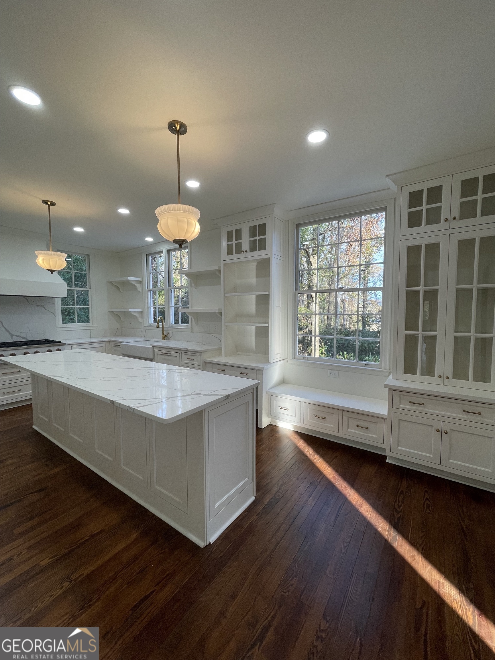 408 Thurston Avenue Thomaston, GA 30286 - Photo 13 of 51 a large kitchen with granite countertop a stove a sink a window and a dining table
