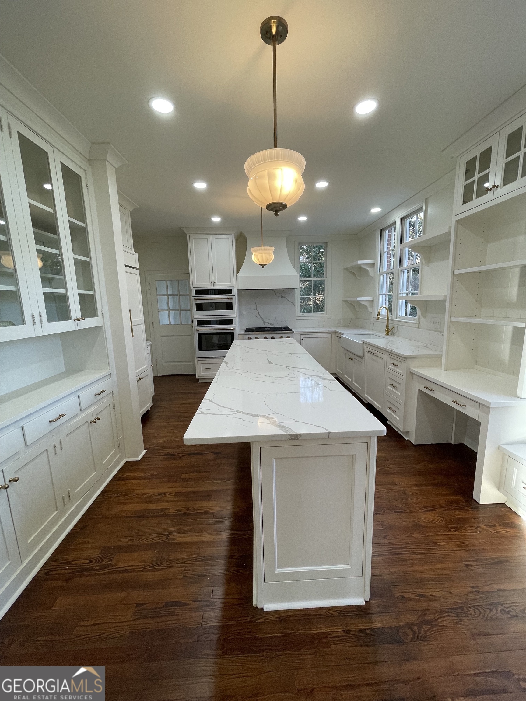 408 Thurston Avenue Thomaston, GA 30286 - Photo 14 of 51 a view of a kitchen with granite countertop sink stove and wooden floor