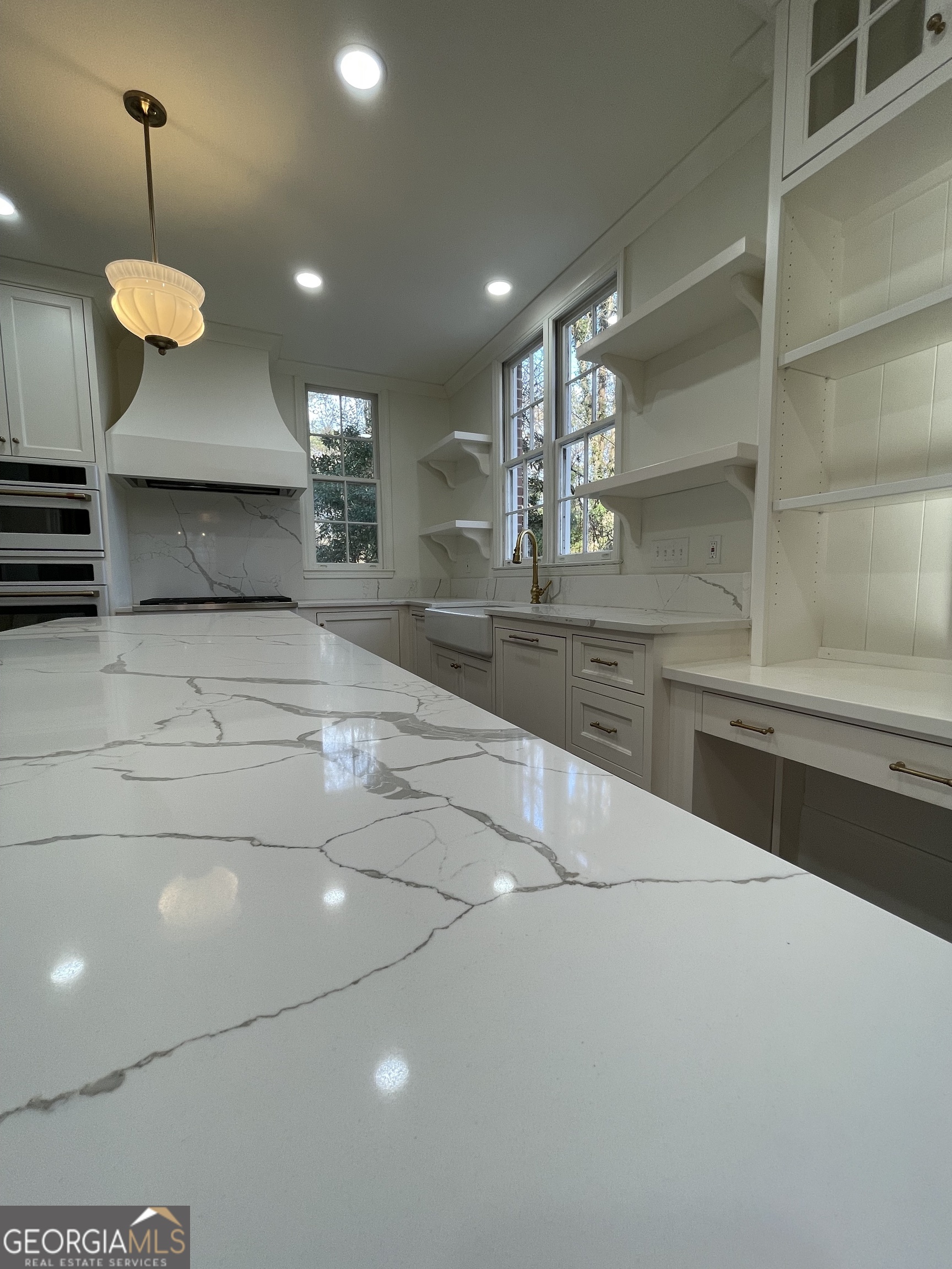 408 Thurston Avenue Thomaston, GA 30286 - Photo 16 of 51 a large kitchen with stainless steel appliances a large counter top a stove and a wooden floors