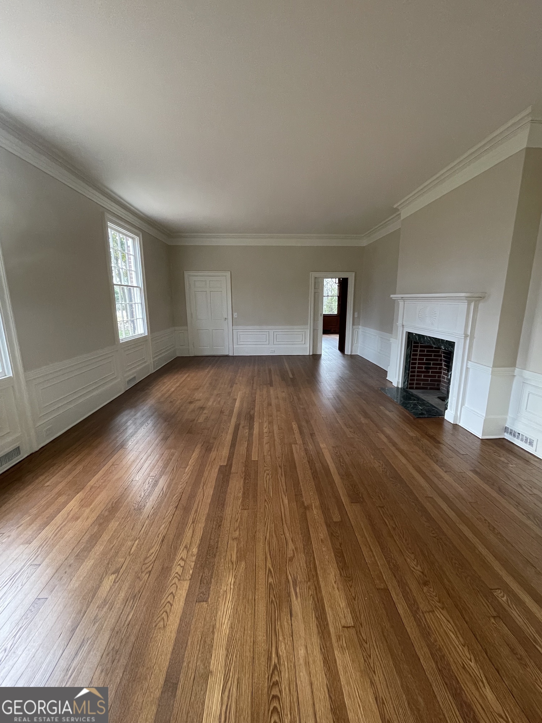408 Thurston Avenue Thomaston, GA 30286 - Photo 24 of 51 a view of empty room with wooden floor and fireplace
