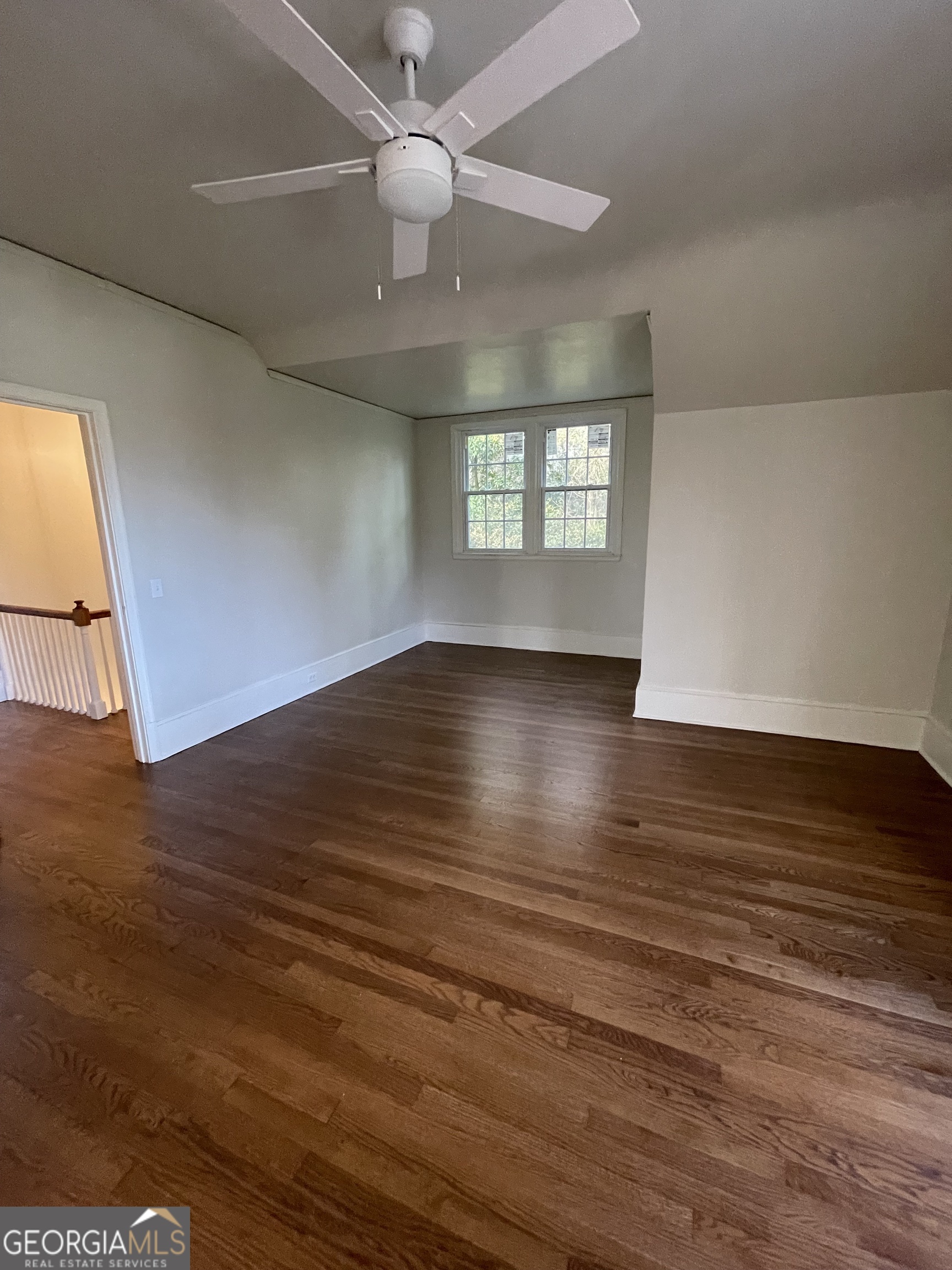 408 Thurston Avenue Thomaston, GA 30286 - Photo 33 of 51 an empty room with wooden floor chandelier fan and windows