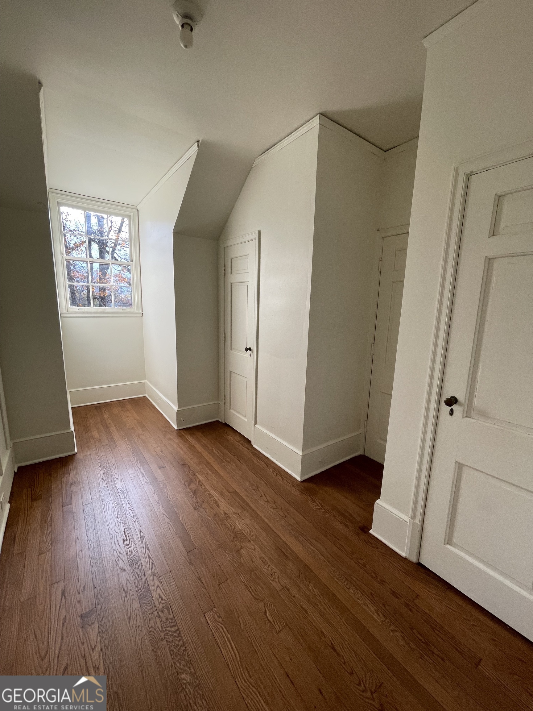 408 Thurston Avenue Thomaston, GA 30286 - Photo 35 of 51 an empty room with wooden floor and windows