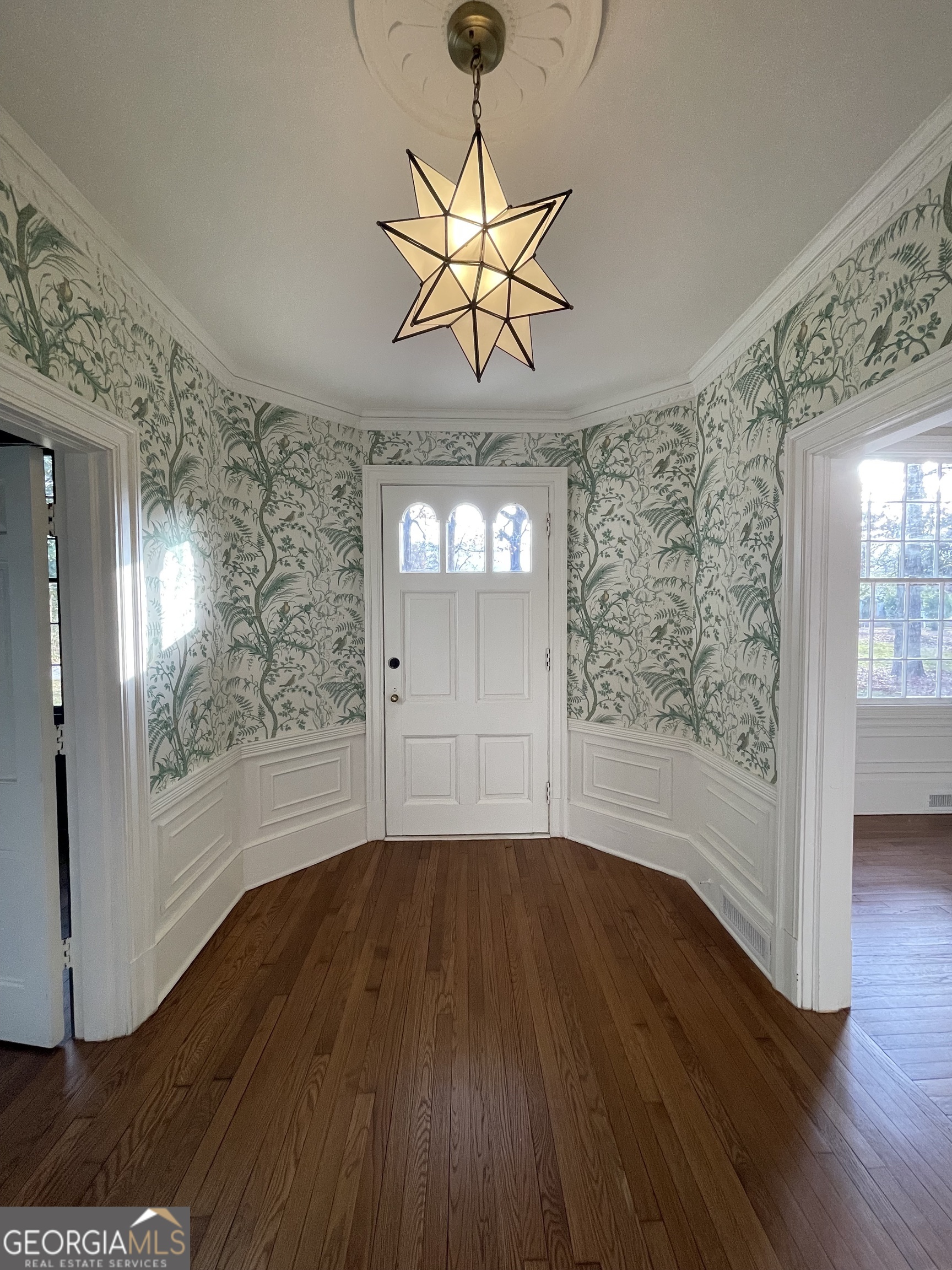 408 Thurston Avenue Thomaston, GA 30286 - Photo 7 of 51 a view of a livingroom with wooden floor a ceiling fan and windows