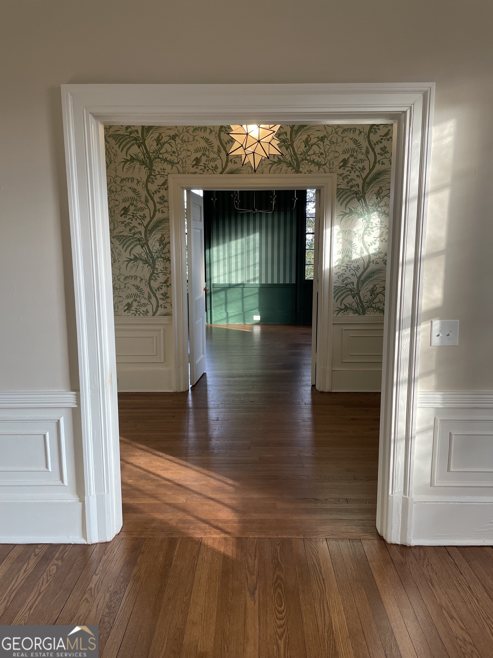 408 Thurston Avenue Thomaston, GA 30286 - Photo 8 of 51 a view of a hallway with wooden floor and windows