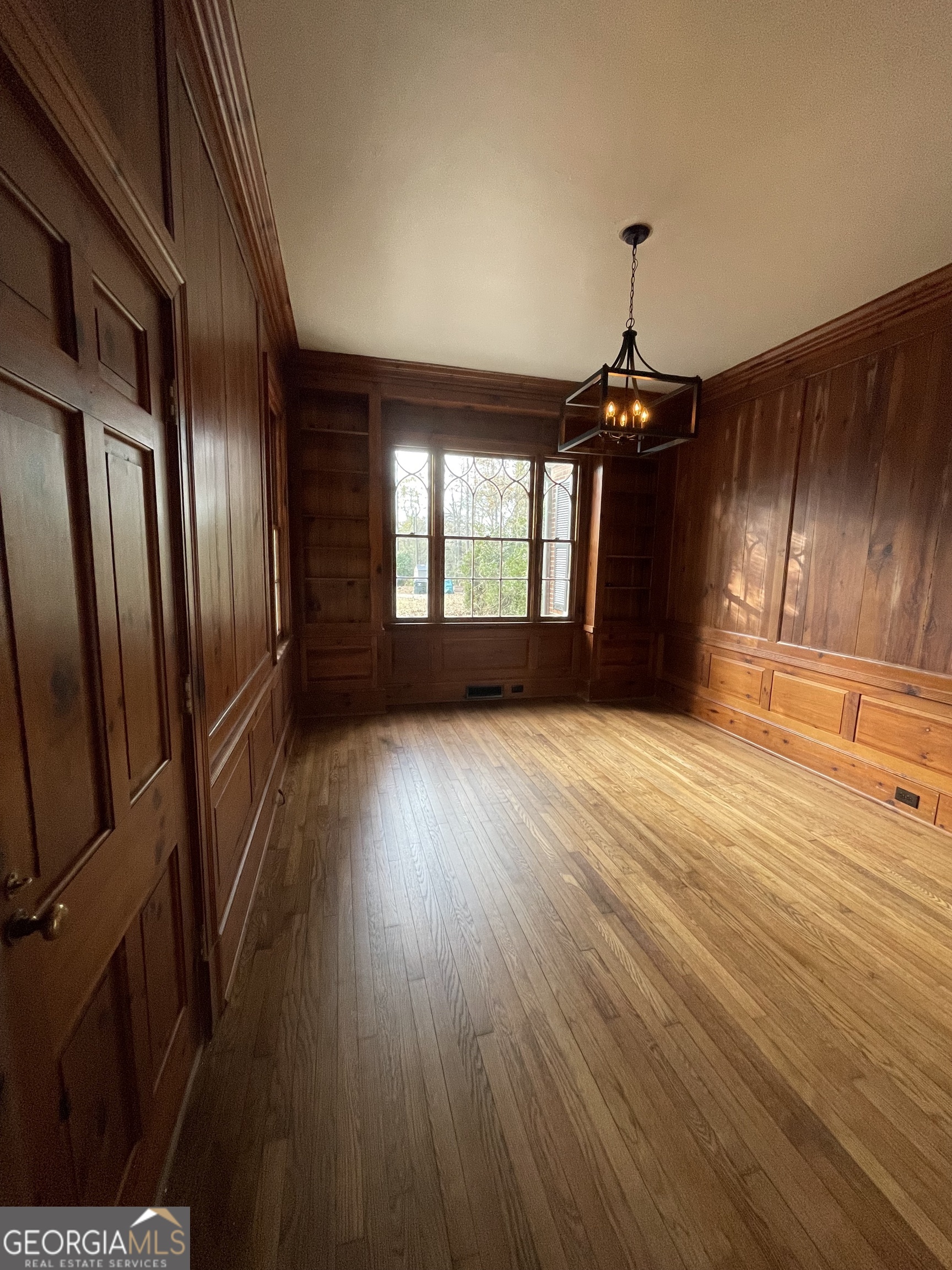 408 Thurston Avenue Thomaston, GA 30286 - Photo 9 of 51 an empty room with wooden floor and windows
