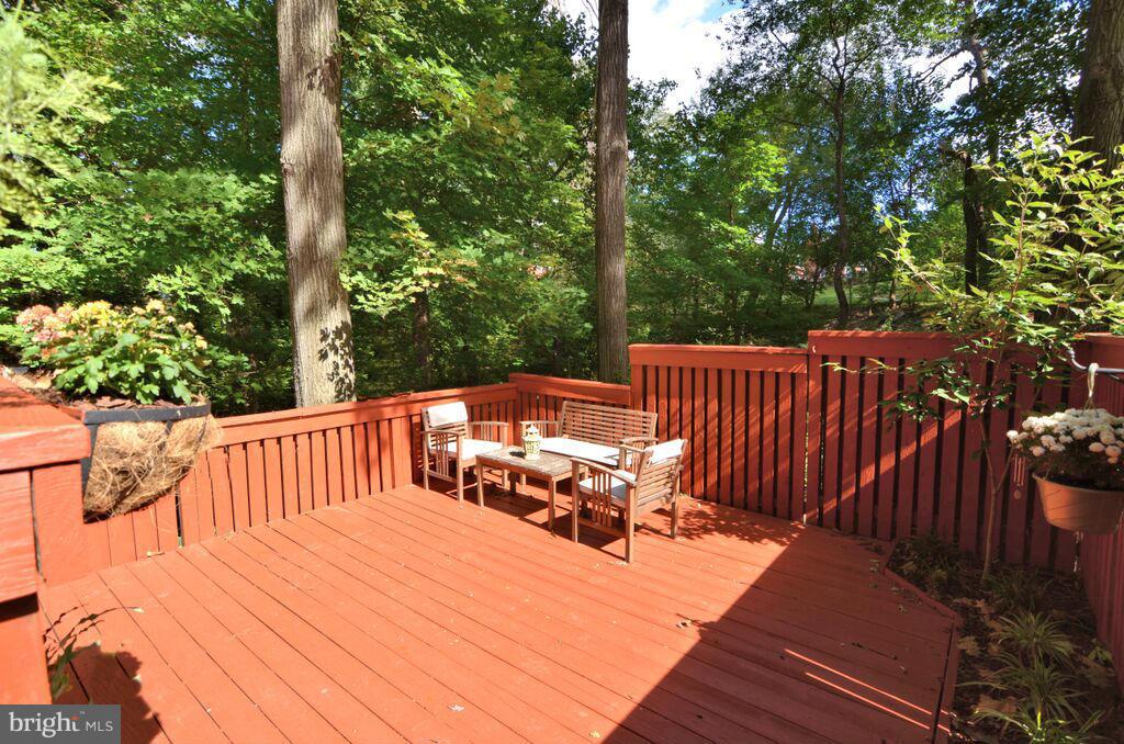 a view of backyard with deck and outdoor seating