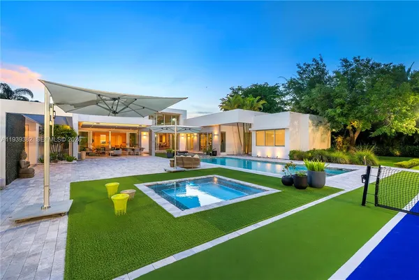 a view of an house with swimming pool and porch