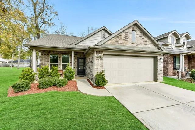 a front view of a house with garden