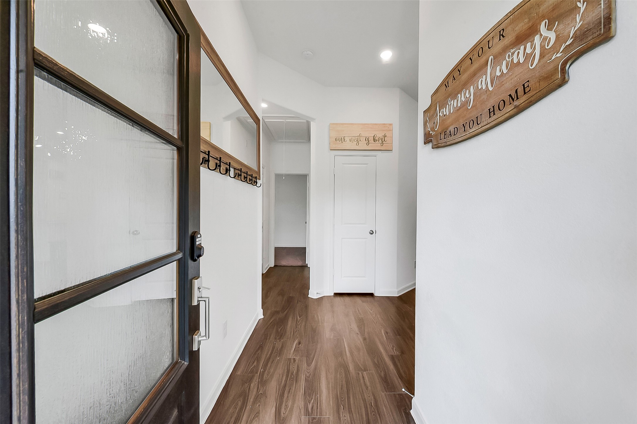 1004 Bulwark Crosby, TX 77532 - Photo 4 of 29 a view of a hallway with wooden floor and staircase