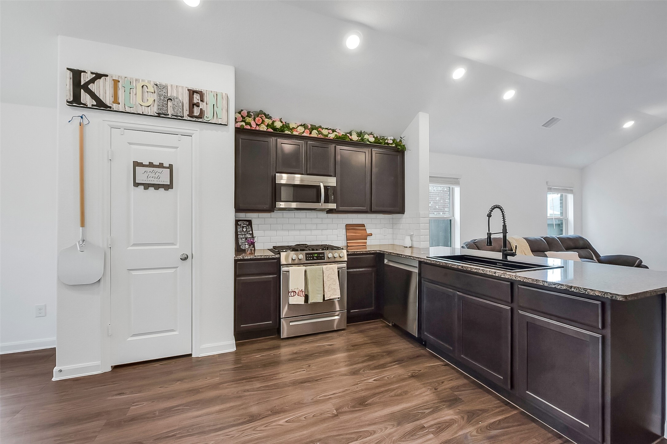 1004 Bulwark Crosby, TX 77532 - Photo 10 of 29 a kitchen with stainless steel appliances granite countertop a refrigerator and a stove top oven