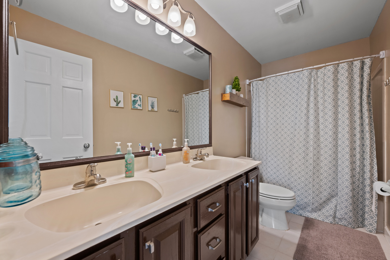 1115 Fagan Road Batavia, IL 60510 - Photo 22 of 33 a bathroom with a double vanity sink toilet and a mirror