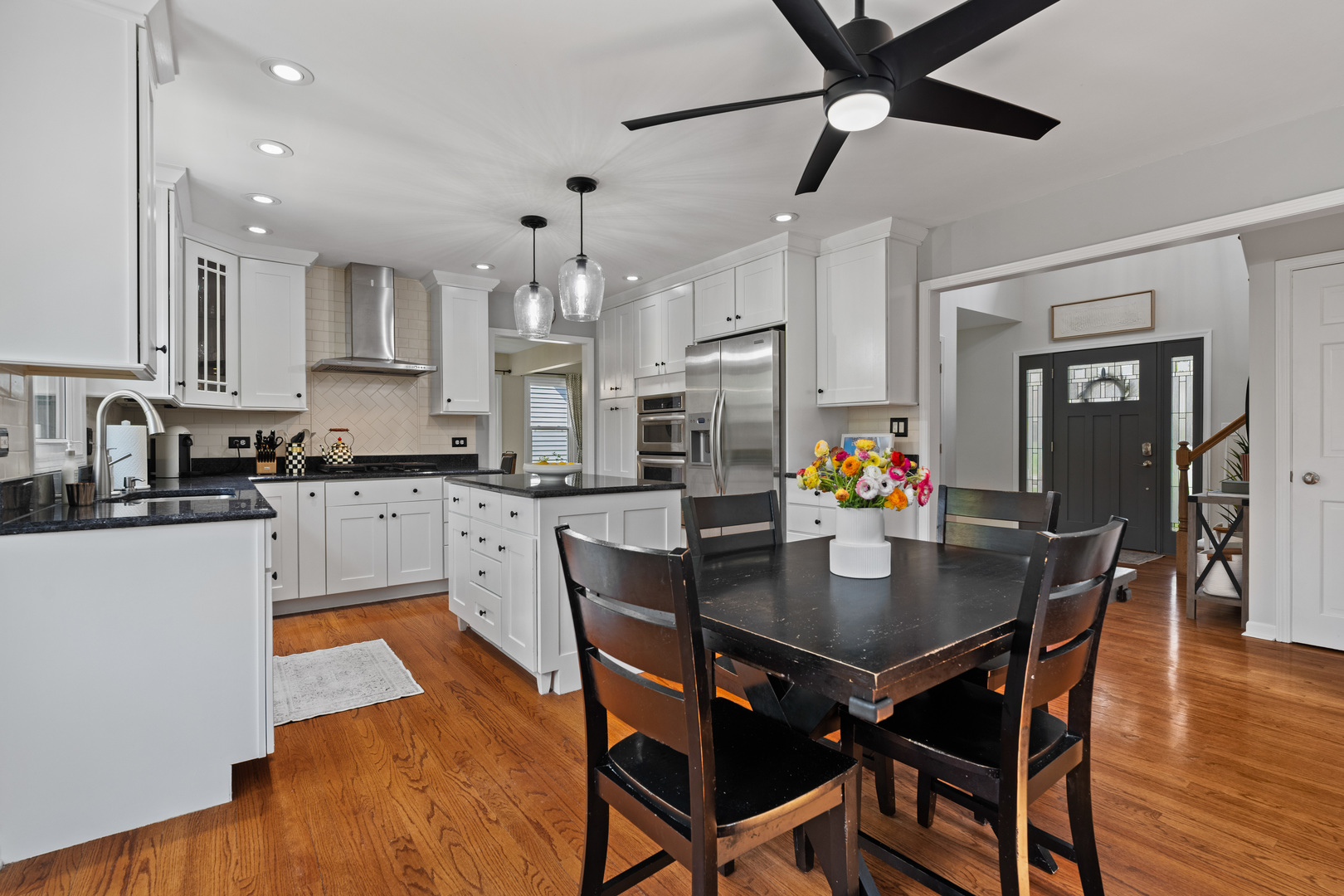 1115 Fagan Road Batavia, IL 60510 - Photo 7 of 33 a kitchen with granite countertop kitchen island stainless steel appliances sink dining table and chairs