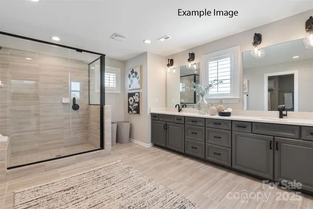 a spacious bathroom with a double vanity sink shower and a mirror