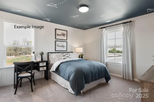 a spacious bedroom with a bed and a table in it