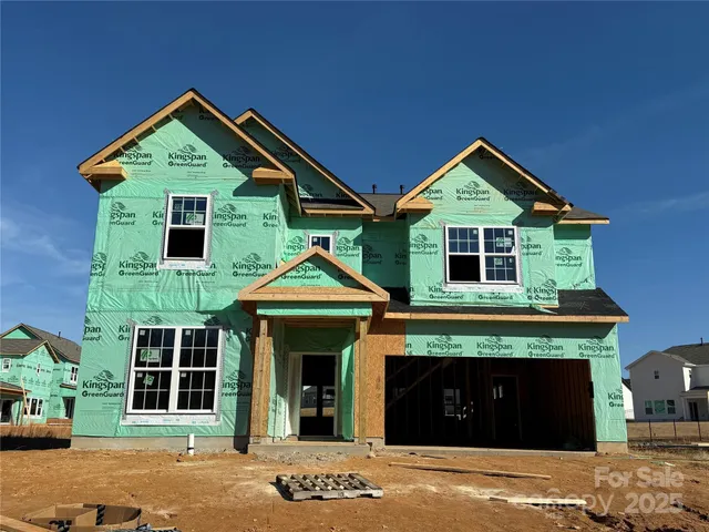 a front view of a house with garage