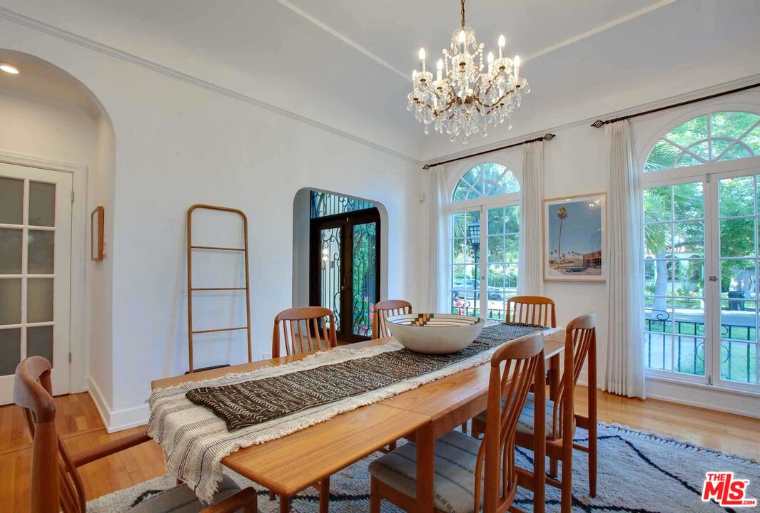 6354 Warner Drive Los Angeles, CA 90048 - Photo 11 of 43 a view of a dining room with furniture a chandelier and wooden floor