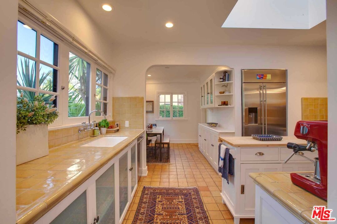 6354 Warner Drive Los Angeles, CA 90048 - Photo 13 of 43 a large kitchen with stainless steel appliances a lot of counter space and a window