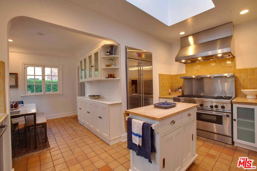 6354 Warner Drive Los Angeles, CA 90048 - Photo 14 of 43 a kitchen with a stove top oven sink and cabinets