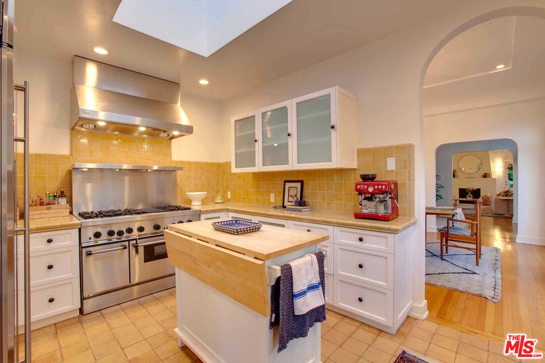 6354 Warner Drive Los Angeles, CA 90048 - Photo 15 of 43 a kitchen with cabinets appliances and a counter top space