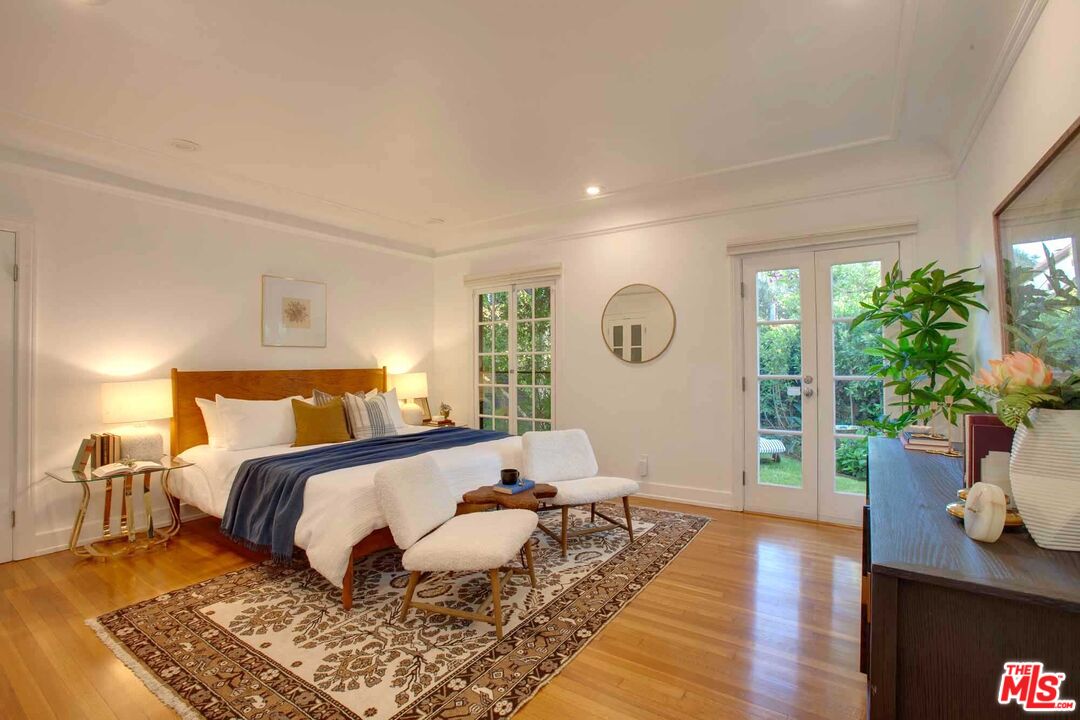 6354 Warner Drive Los Angeles, CA 90048 - Photo 21 of 43 a bed room with a bed lamp potted plant and a window