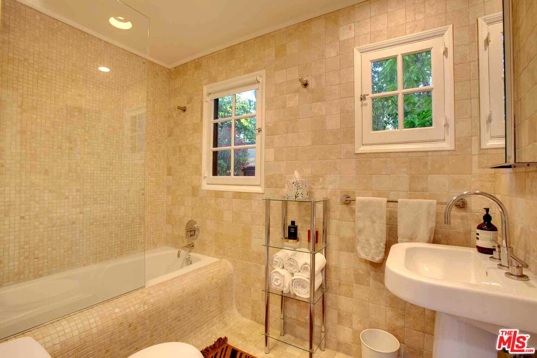 6354 Warner Drive Los Angeles, CA 90048 - Photo 22 of 43 a bath room with a sink and a bath tub