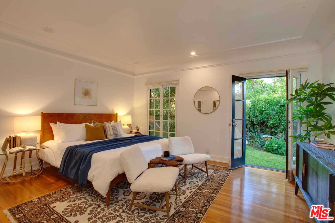 6354 Warner Drive Los Angeles, CA 90048 - Photo 23 of 43 a bed room with a bed couch and garden view