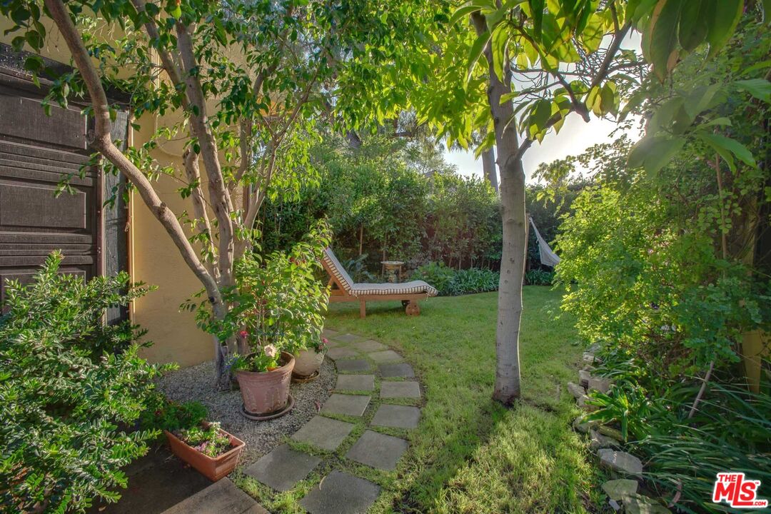 6354 Warner Drive Los Angeles, CA 90048 - Photo 34 of 43 a view of a garden with potted plants and large trees