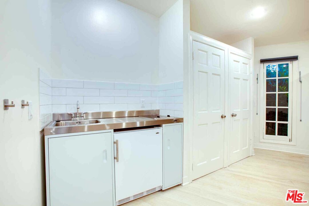 6354 Warner Drive Los Angeles, CA 90048 - Photo 37 of 43 a kitchen with a sink a stove and cabinets