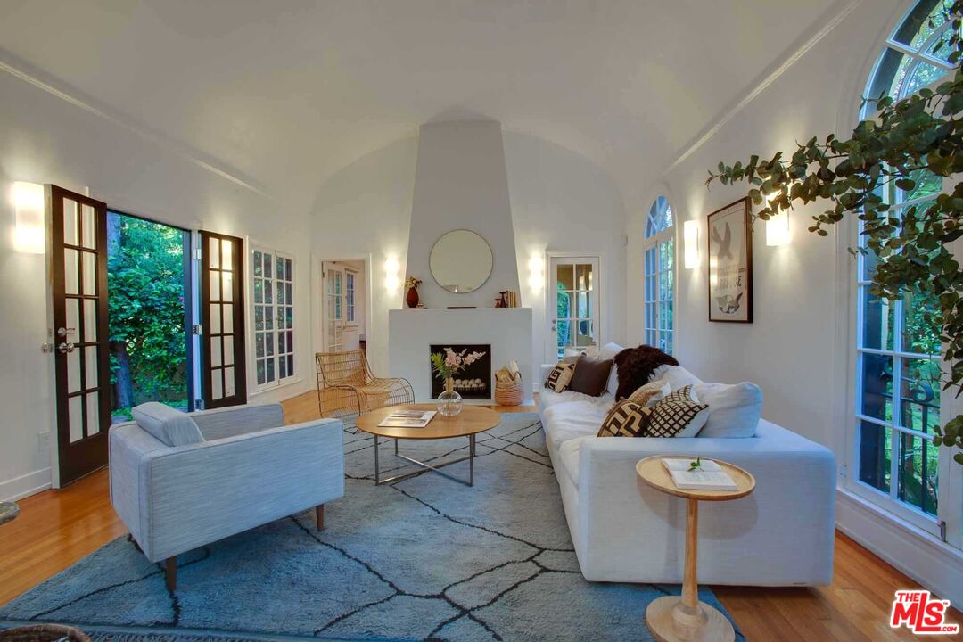 6354 Warner Drive Los Angeles, CA 90048 - Photo 5 of 43 a living room with fireplace furniture and a large window