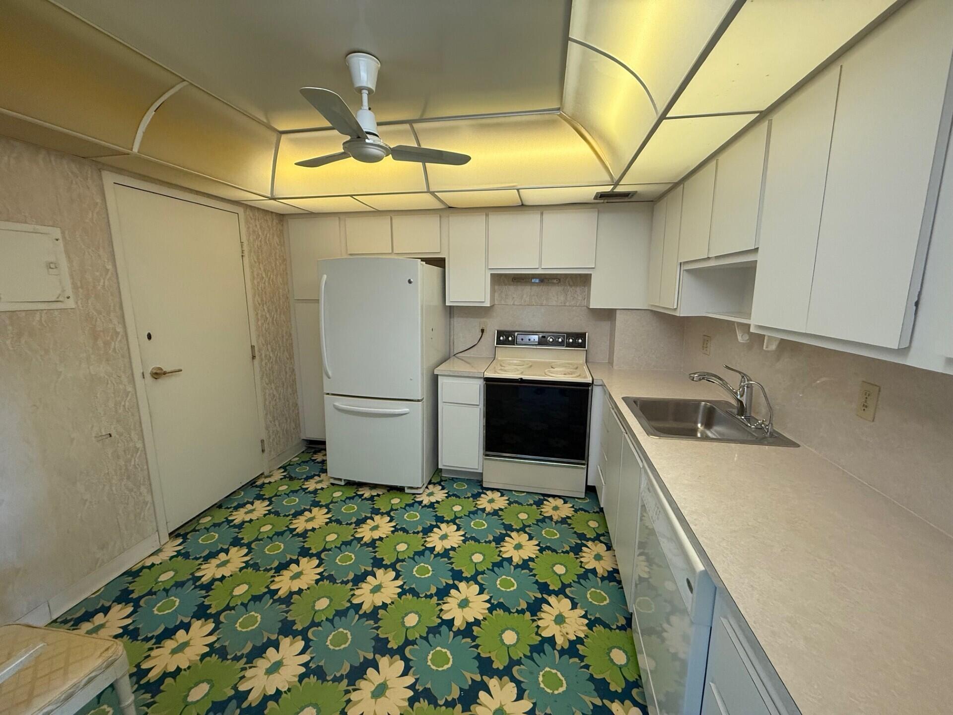 3450 South Ocean Boulevard, Unit 819 Palm Beach, FL 33480 - Photo 15 of 37 a kitchen with a sink and refrigerator