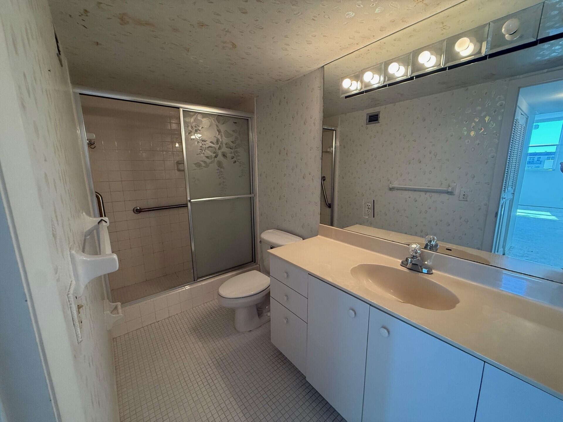 3450 South Ocean Boulevard, Unit 819 Palm Beach, FL 33480 - Photo 18 of 37 a bathroom with a sink a toilet and shower