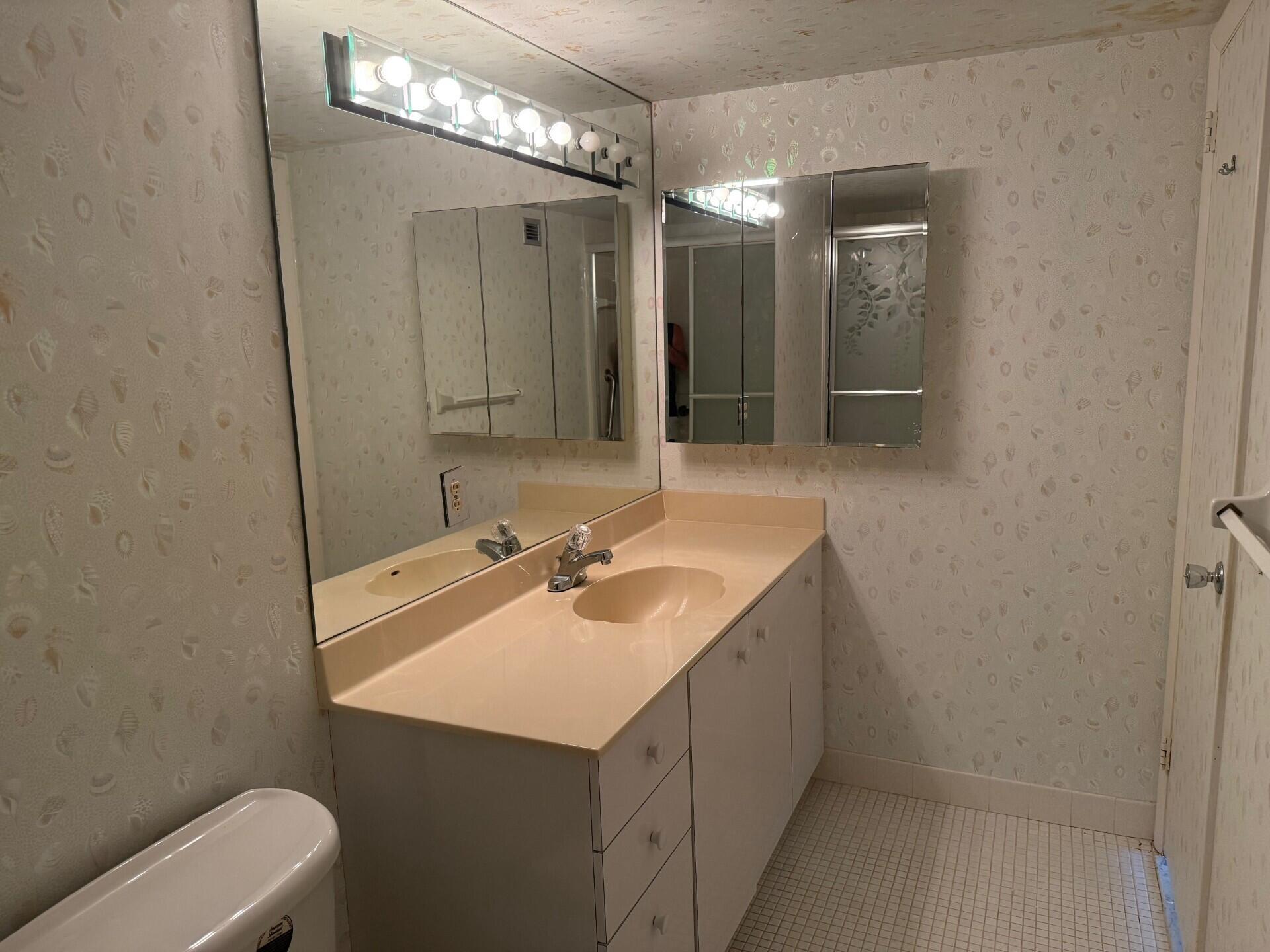 3450 South Ocean Boulevard, Unit 819 Palm Beach, FL 33480 - Photo 19 of 37 a bathroom with a sink and a mirror