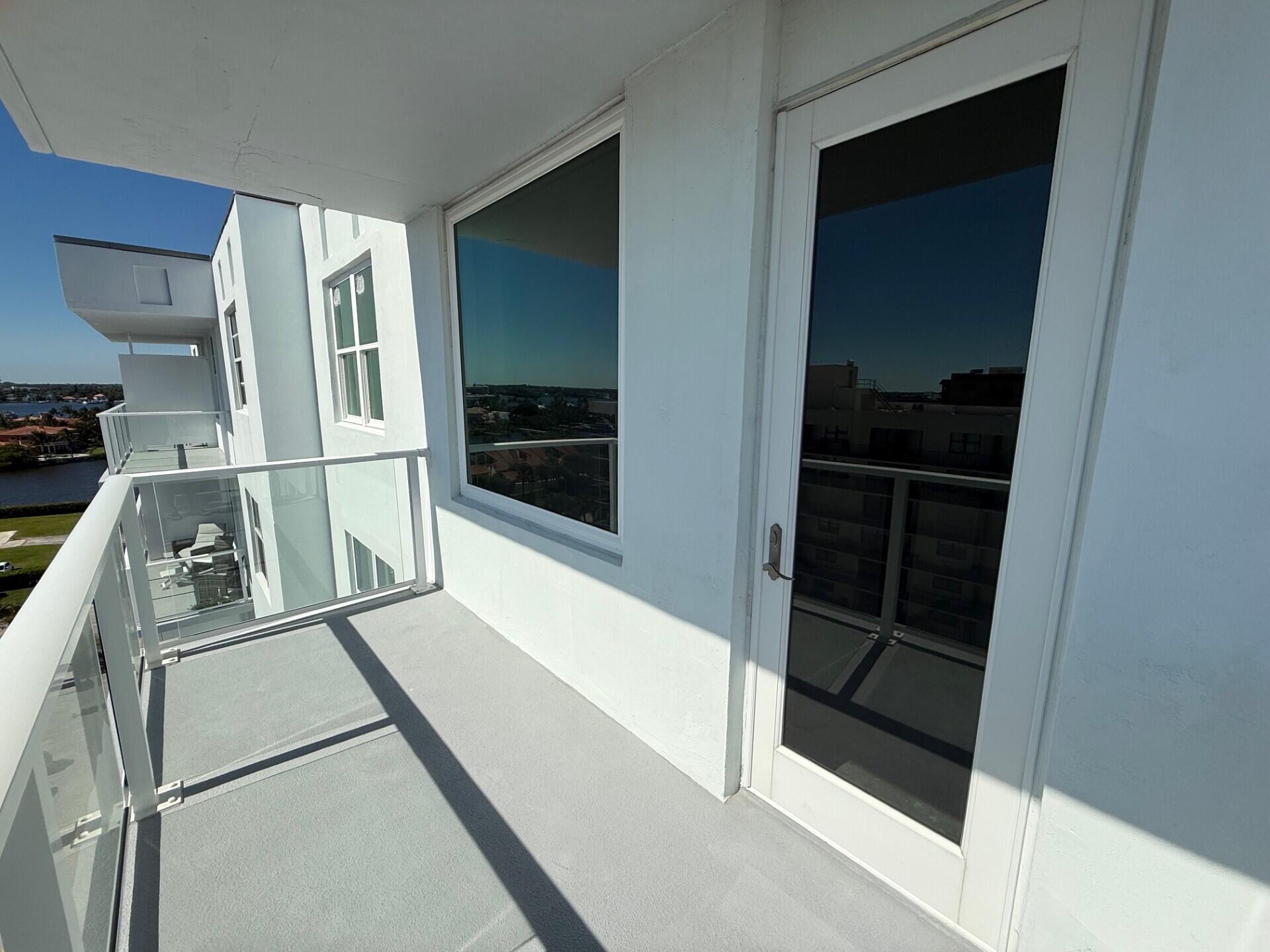 3450 South Ocean Boulevard, Unit 819 Palm Beach, FL 33480 - Photo 22 of 37 a kitchen with a refrigerator and white cabinets
