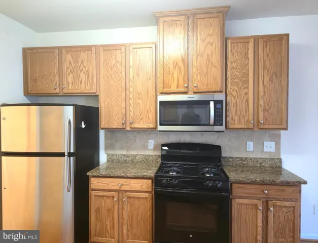 a kitchen with a stove and a microwave