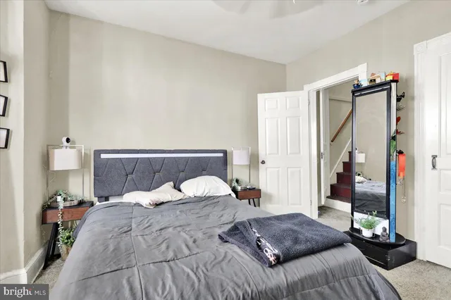 a bedroom with a large bed and a potted plant