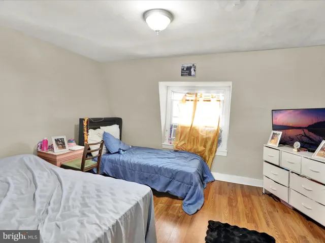a bedroom with two beds and painted chair