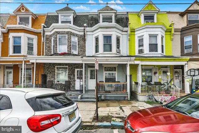 a front view of a multi story residential apartment building with swimming pool