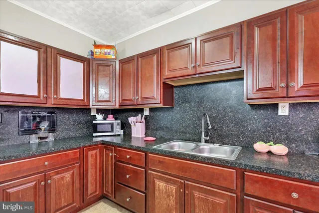 a kitchen with stainless steel appliances granite countertop a sink dishwasher stove and cabinets with wooden floor