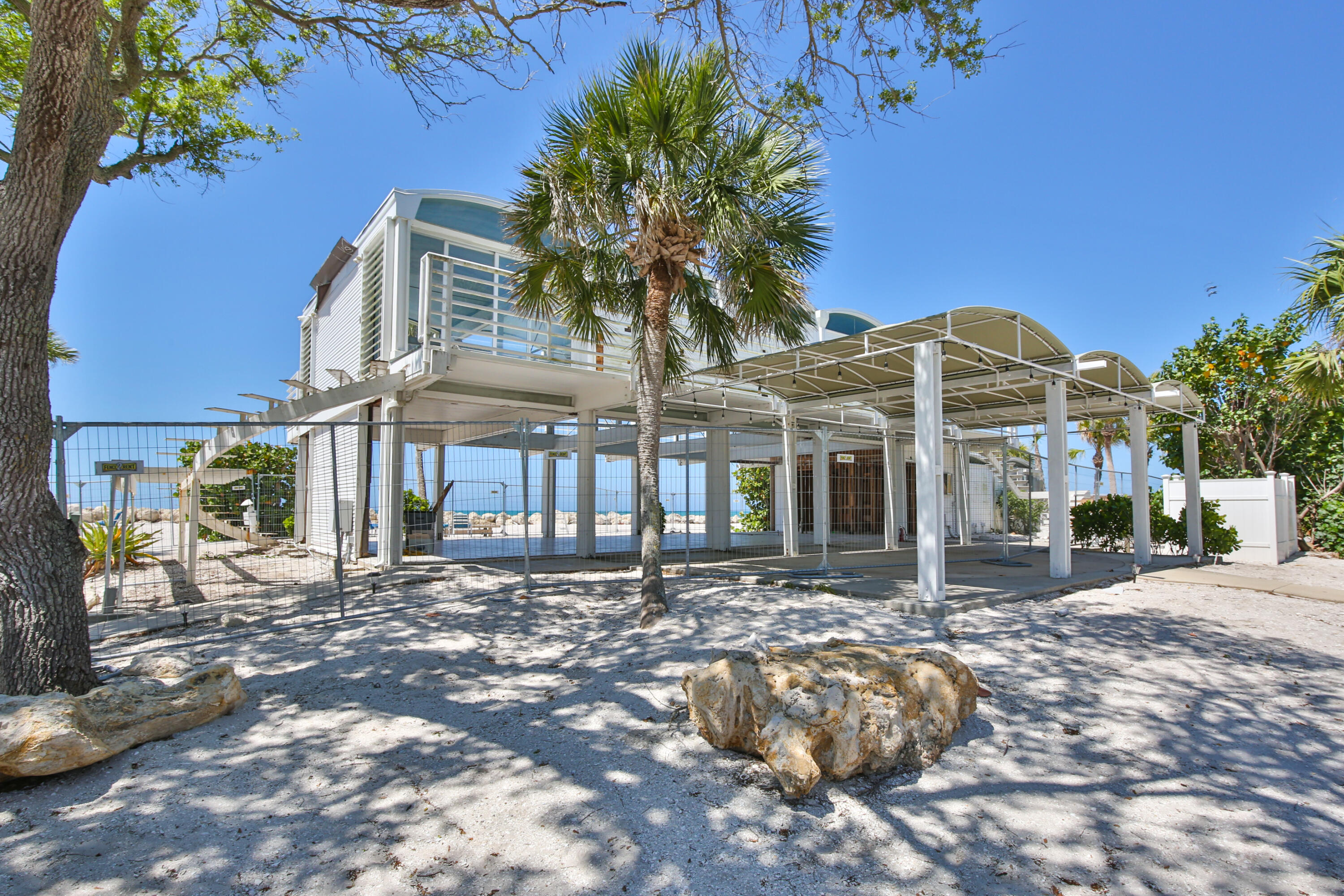 7816 Sanderling Road Sarasota, FL 34242 - Photo 26 of 34 a front view of a building with a garden