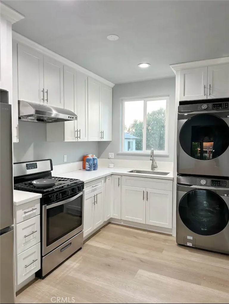 a kitchen with a stove top oven sink and cabinets