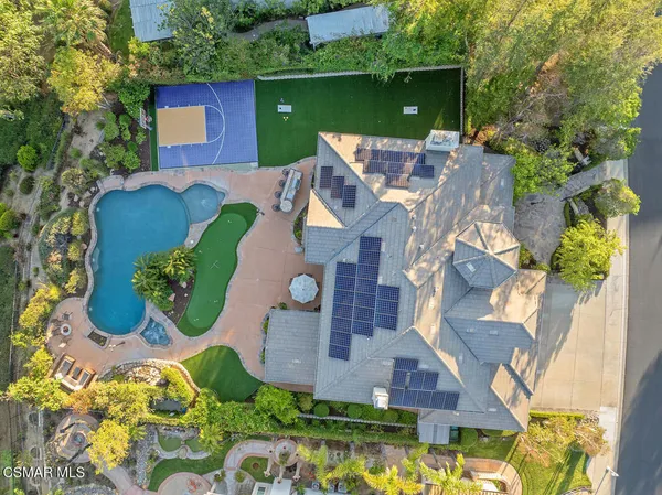 a view of a house with backyard and sitting area