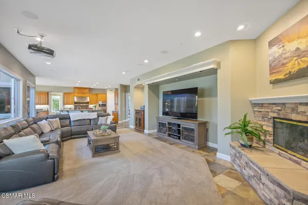 a living room with furniture a fireplace and a large mirror