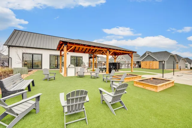 a view of a patio with a table and chairs